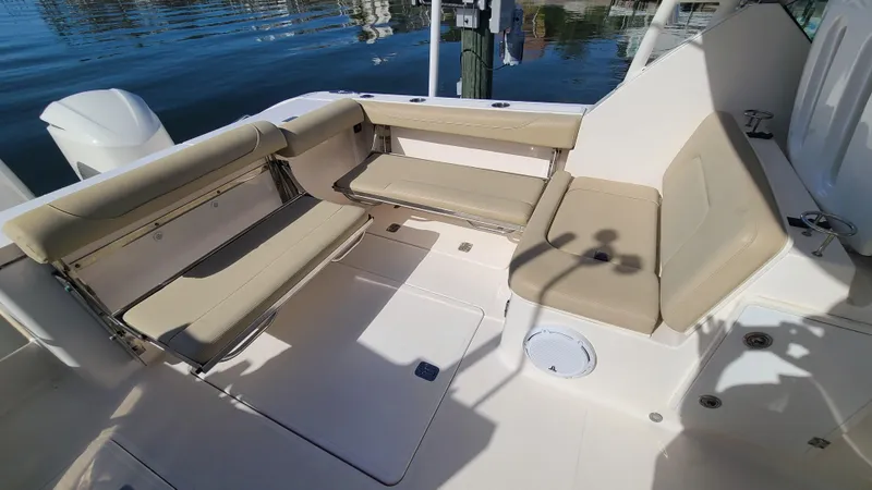  Yacht Photos Pics 2016 Pursuit DC 325 Dual Console boat interior with beige seating and open deck.