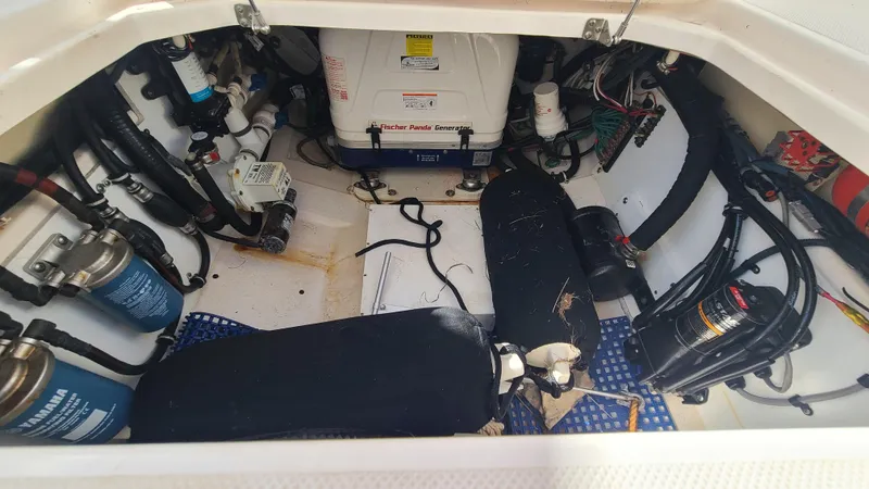  Yacht Photos Pics 2016 Pursuit DC 325 Dual Console engine compartment with various mechanical components and wiring.