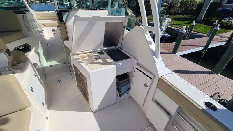  Yacht Photos Pics 2016 Pursuit DC 325 Dual Console boat interior with open storage and seating area.