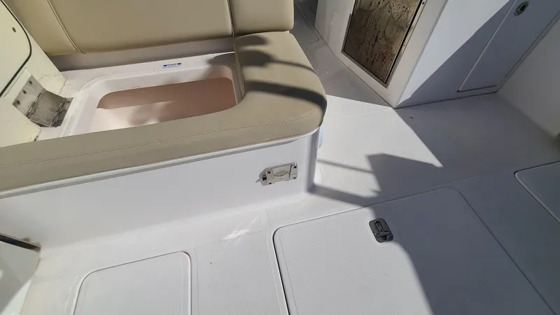  Yacht Photos Pics 2016 Pursuit DC 325 Dual Console boat interior with beige seating and storage compartments.