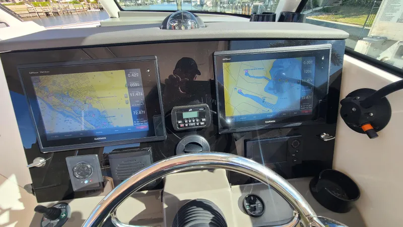  Yacht Photos Pics 2016 Pursuit DC 325 Dual Console dashboard with dual navigation screens and steering wheel.