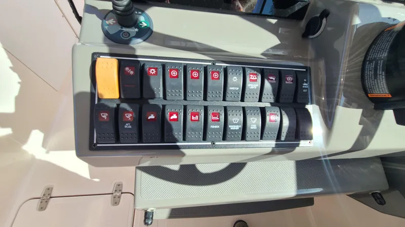  Yacht Photos Pics Control panel of a 2016 Pursuit DC 325 Dual Console boat with labeled switches.
