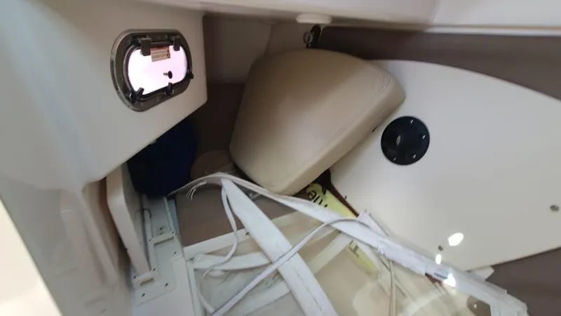  Yacht Photos Pics 2016 Pursuit DC 325 Dual Console interior storage area with cushions and hatch.