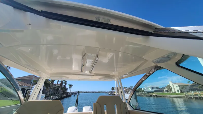  Yacht Photos Pics 2016 Pursuit DC 325 Dual Console boat interior with waterfront view.