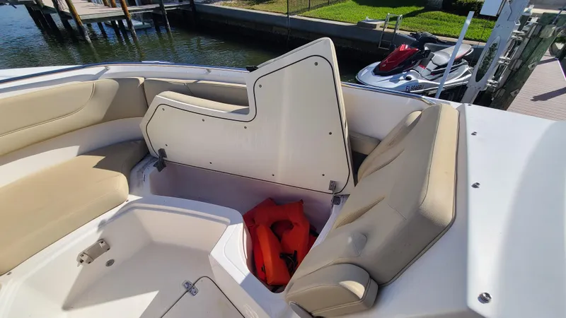  Yacht Photos Pics 2016 Pursuit DC 325 Dual Console boat interior with beige seating and storage compartment.