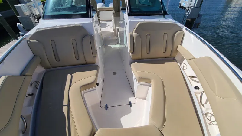  Yacht Photos Pics 2016 Pursuit DC 325 Dual Console boat interior with beige seating and open deck layout.