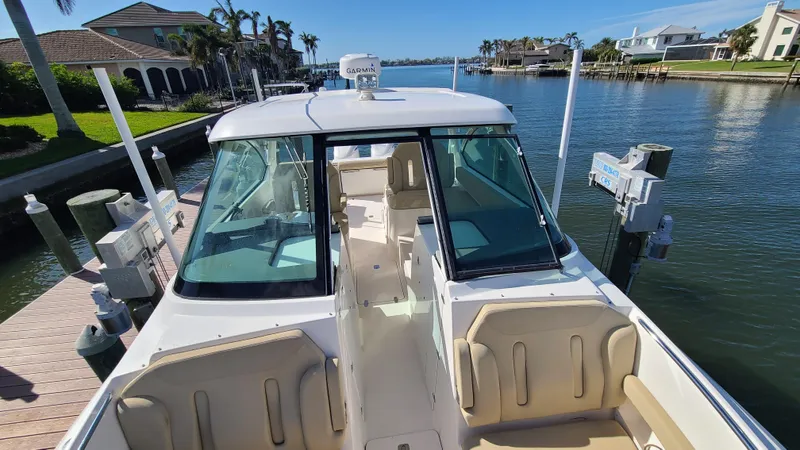  Yacht Photos Pics 2016 Pursuit DC 325 Dual Console boat docked by waterfront homes.