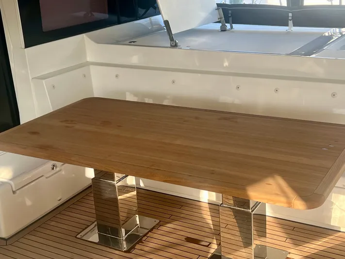  Yacht Photos Pics Luxurious wooden table on 2017 Lagoon 620 yacht deck, featuring sleek design and modern finishes.