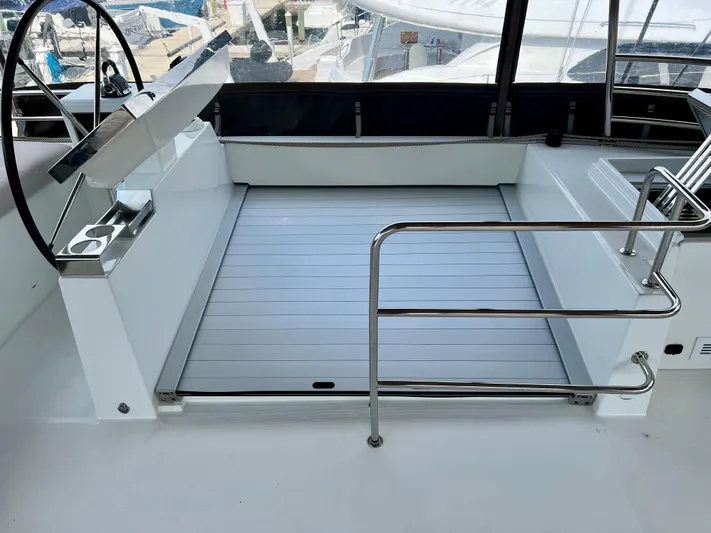  Yacht Photos Pics Helm station of 2017 Lagoon 620 catamaran with sleek design and stainless steel railings.
