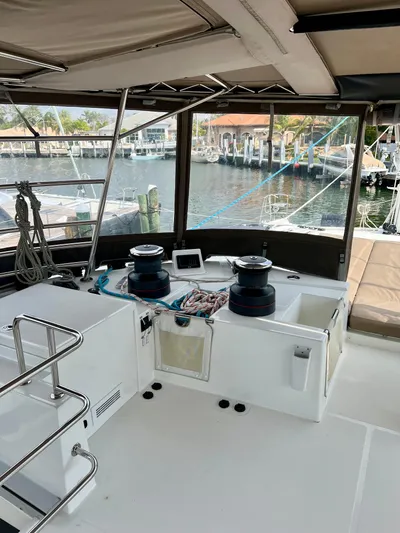  Yacht Photos Pics 2017 Lagoon 620 yacht cockpit with winches and navigation equipment, docked at a marina.