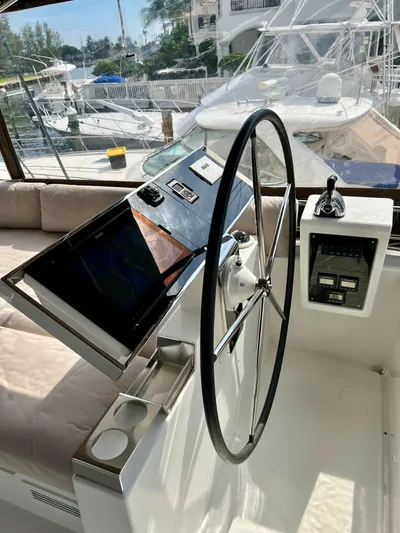  Yacht Photos Pics Steering wheel and controls of a 2017 Lagoon 620 yacht, docked at a marina.