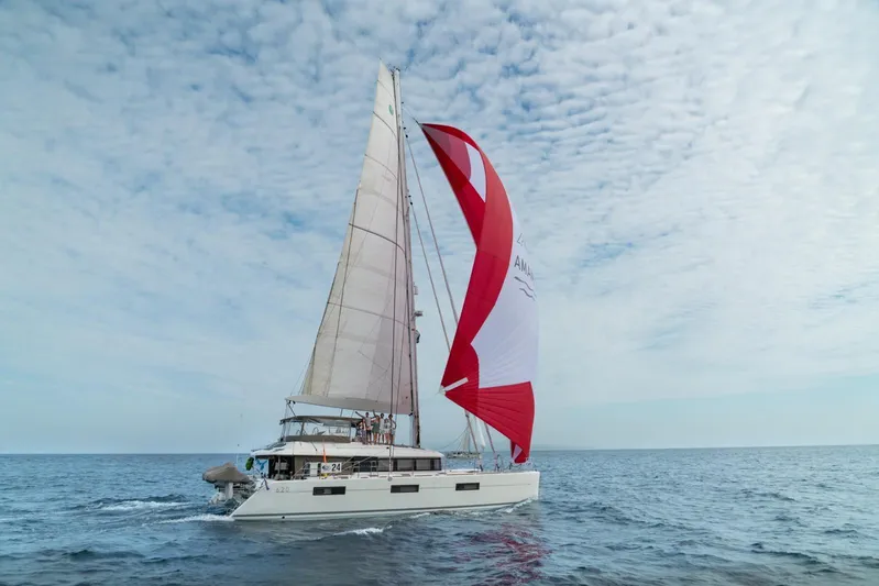  Yacht Photos Pics 2017 Lagoon 620 catamaran sailing on open sea under cloudy sky.