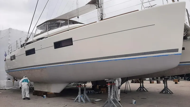  Yacht Photos Pics 2017 Lagoon 620 catamaran on stands, undergoing maintenance in a shipyard.