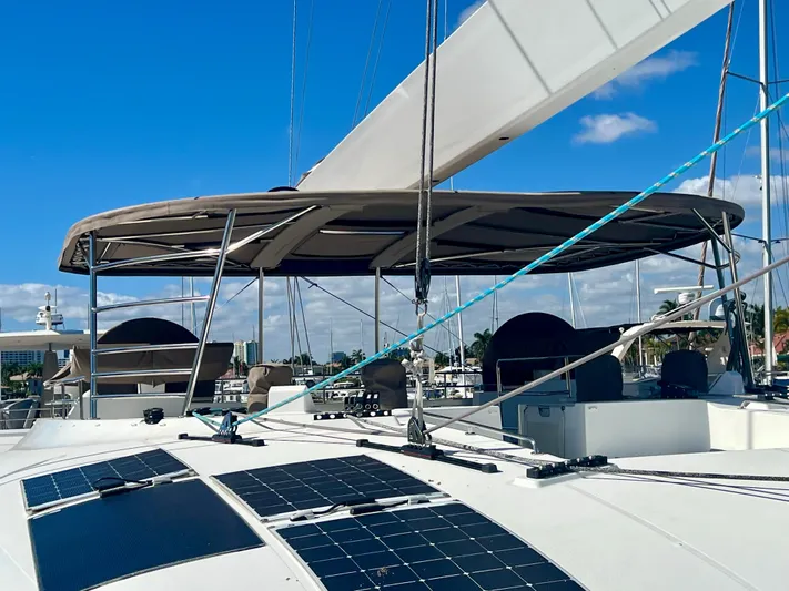  Yacht Photos Pics 2017 Lagoon 620 catamaran with solar panels and sails, docked under a clear blue sky.