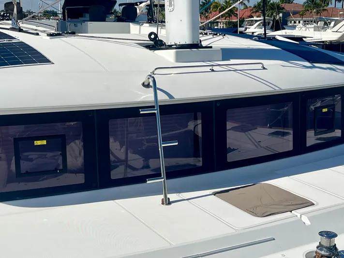 Yacht Photos Pics Lagoon 620 catamaran, 2017 model, featuring sleek windows and deck details in a marina setting.