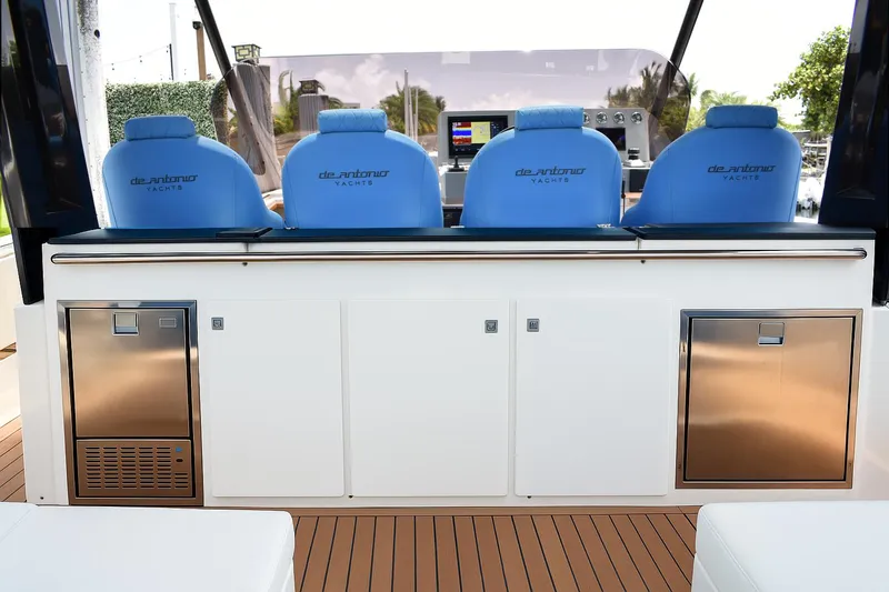  Yacht Photos Pics 2021 De Antonio Yachts D42 interior with blue seats and modern control panel.