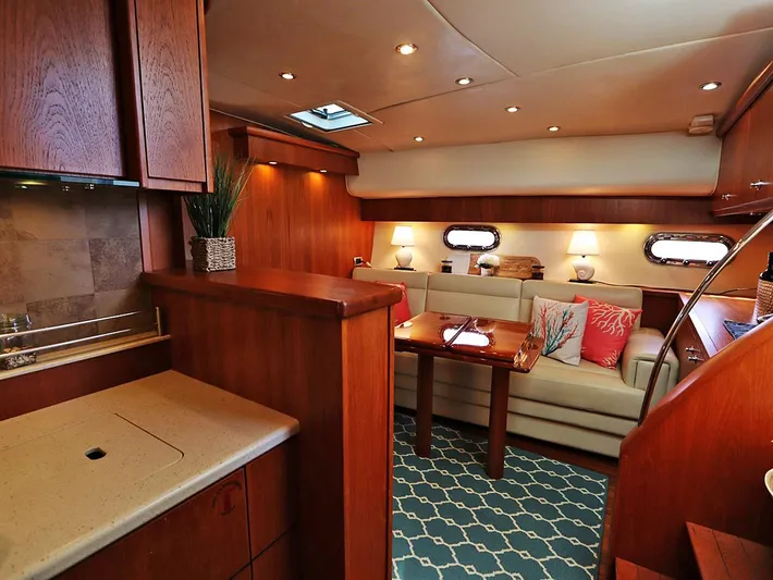 Ocho Yacht Photos Pics Luxurious interior of 2009 Tiara Yachts 4300 Sovran with elegant wood finishes and cozy seating.