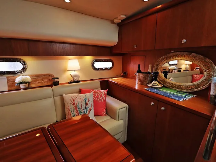 Ocho Yacht Photos Pics Luxurious interior of 2009 Tiara Yachts 4300 Sovran with elegant wood finish and cozy seating.