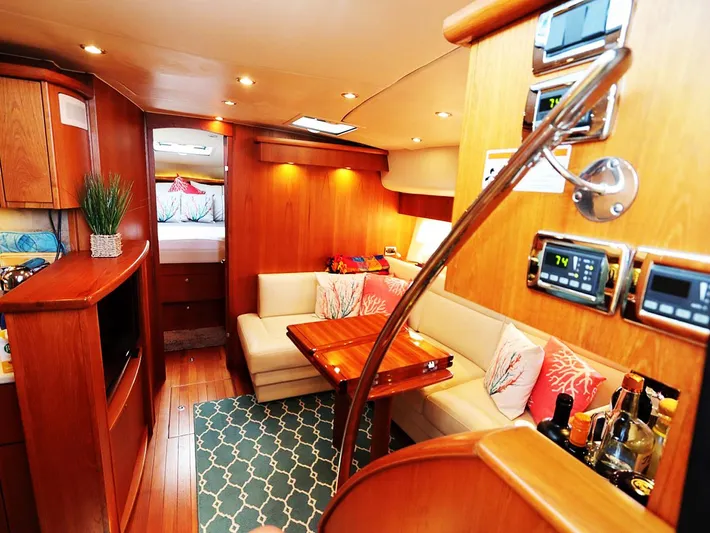 Ocho Yacht Photos Pics Luxurious interior of 2009 Tiara Yachts 4300 Sovran with elegant wood finishes and cozy seating.