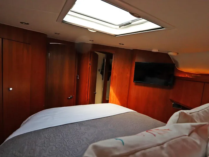 Ocho Yacht Photos Pics Luxurious cabin interior of 2009 Tiara Yachts 4300 Sovran with skylight and TV.