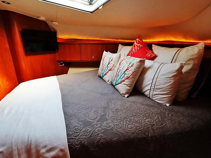 Ocho Yacht Photos Pics Luxurious cabin interior of 2009 Tiara Yachts 4300 Sovran with elegant bedding and ambient lighting.