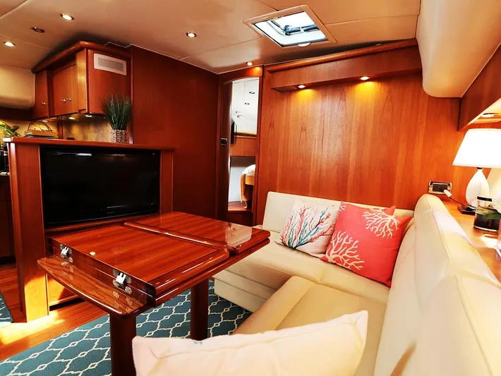 Ocho Yacht Photos Pics Luxurious interior of 2009 Tiara Yachts 4300 Sovran with elegant wood finish and cozy seating.