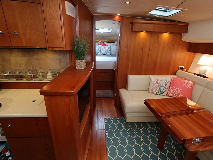 Ocho Yacht Photos Pics Luxurious interior of 2009 Tiara Yachts 4300 Sovran with wood finish and cozy seating area.