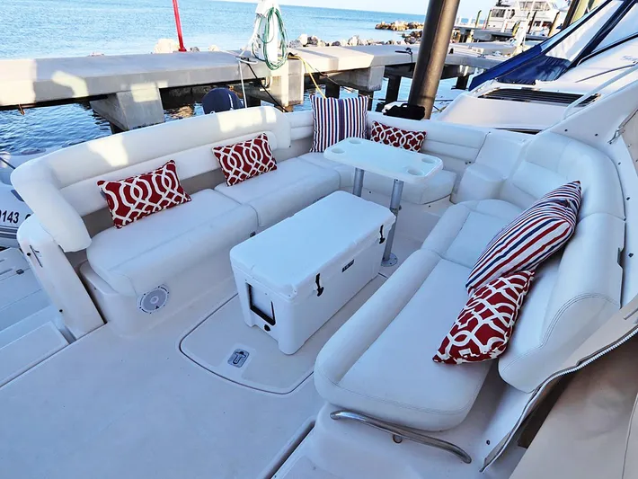 Ocho Yacht Photos Pics 2009 Tiara Yachts 4300 Sovran deck with white seating and red-patterned cushions.