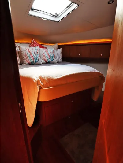 Ocho Yacht Photos Pics Luxurious cabin interior of 2009 Tiara Yachts 4300 Sovran with cozy bedding and ambient lighting.