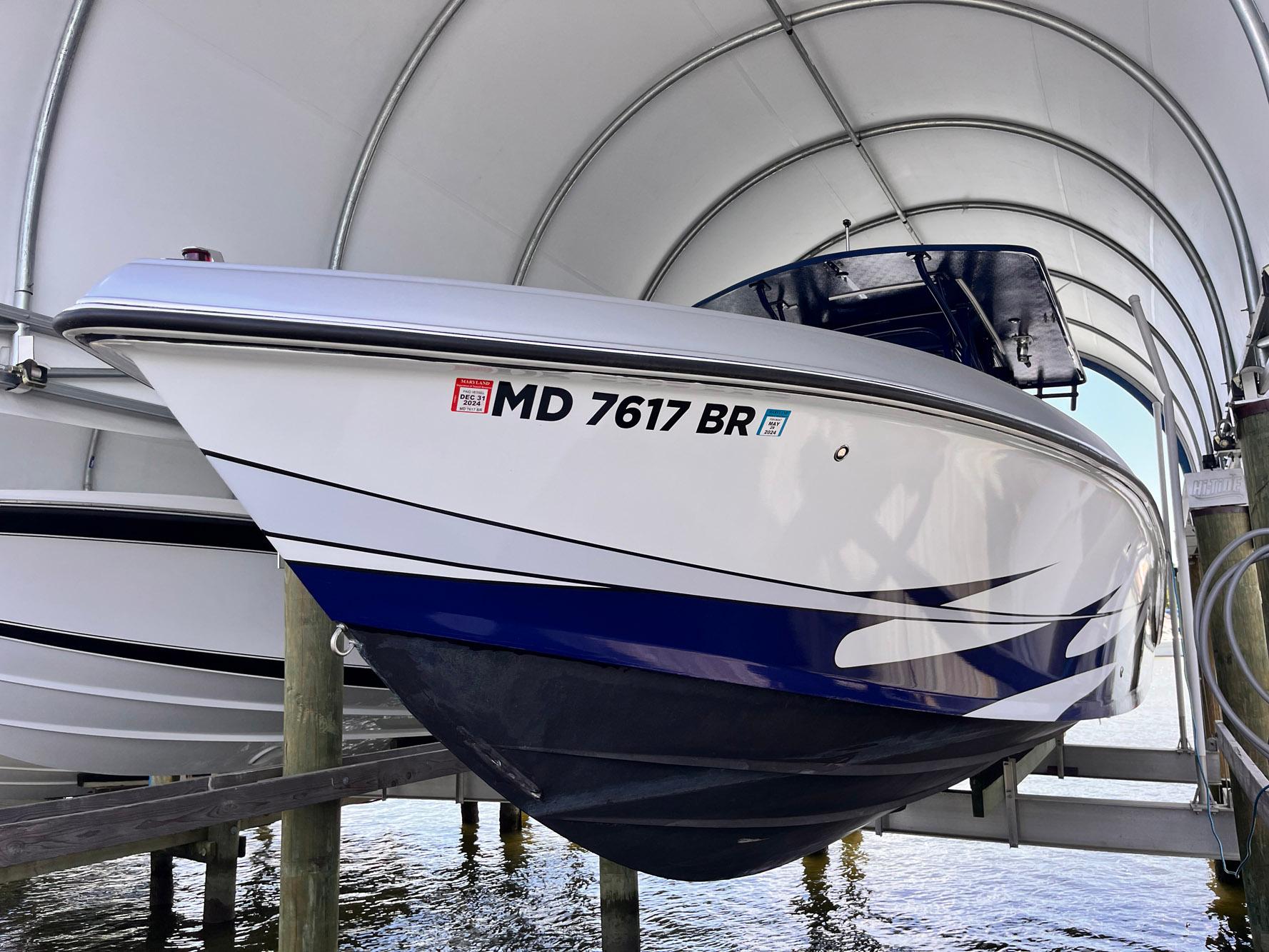 2011 Statement 380 Open boat docked under a canopy, registration MD 7617 BR visible.