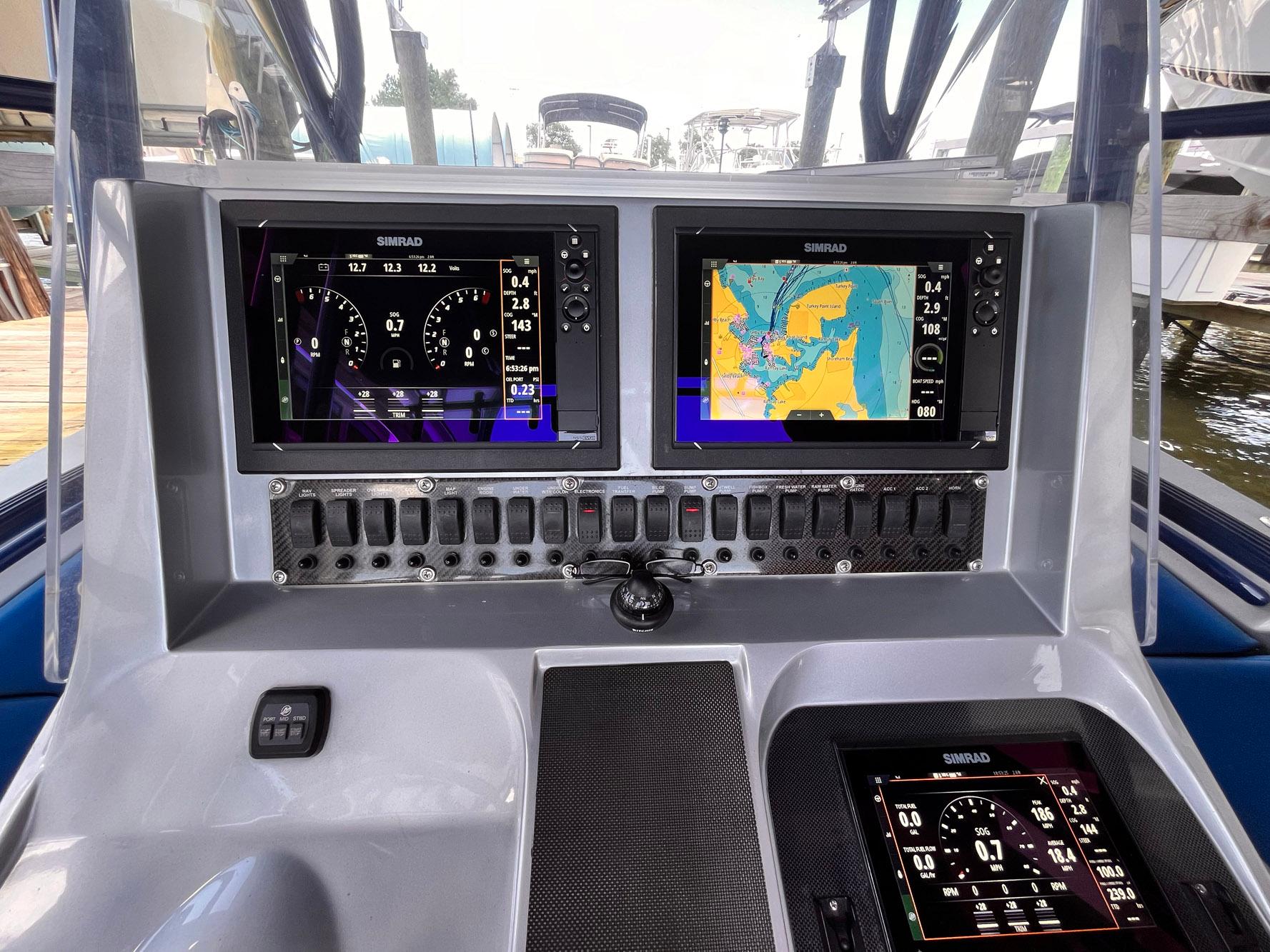 Dashboard of 2011 Statement 380 Open boat with navigation screens and controls.