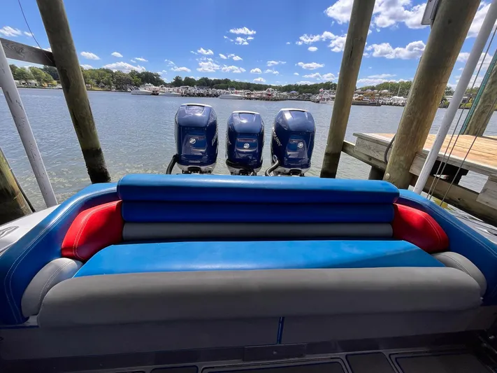  Yacht Photos Pics 2011 Statement 380 Open boat with triple engines docked by a scenic lake.