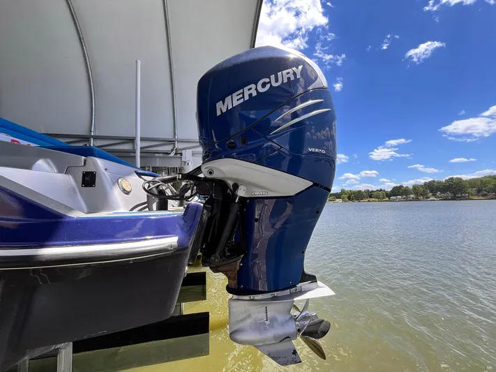  Yacht Photos Pics Mercury outboard motor on 2011 Statement 380 Open boat, docked by a lake.