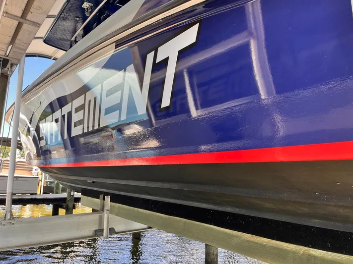  Yacht Photos Pics Blue 2011 Statement 380 Open boat with bold lettering on the side.