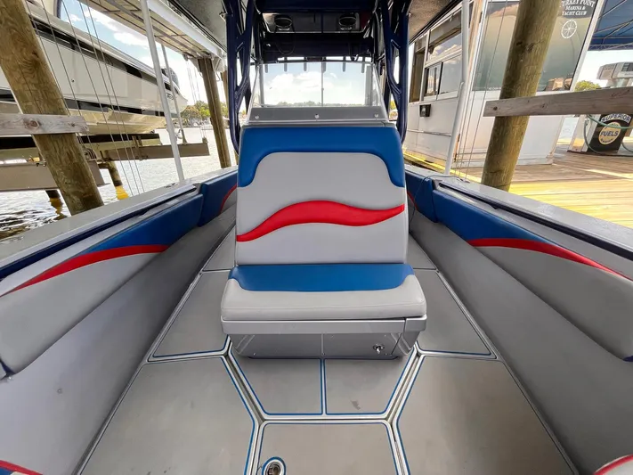  Yacht Photos Pics 2011 Statement 380 Open boat interior with blue and red seating, docked at marina.