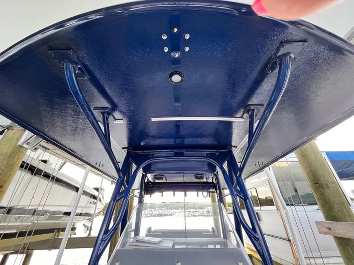  Yacht Photos Pics 2011 Statement 380 Open boat, blue canopy, docked, view from below.
