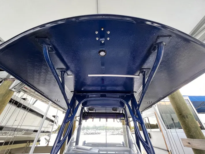  Yacht Photos Pics 2011 Statement 380 Open boat, blue canopy, docked under shelter.