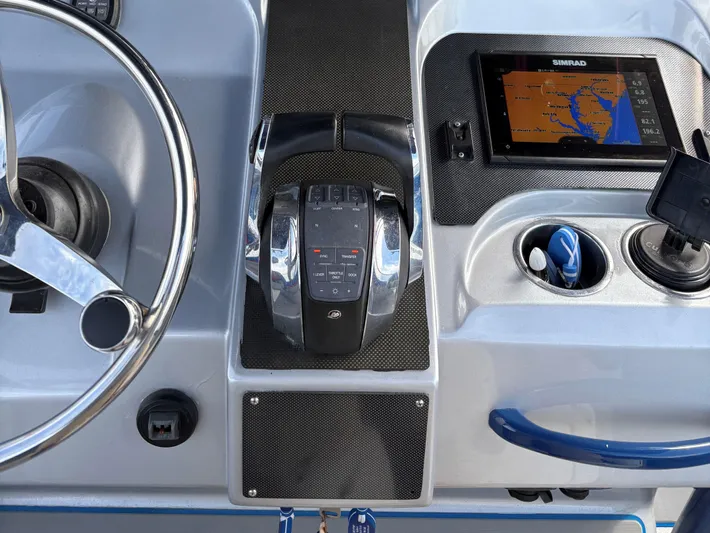  Yacht Photos Pics Boat dashboard with steering wheel, throttle controls, and navigation display on a 2011 Statement 380 Open.