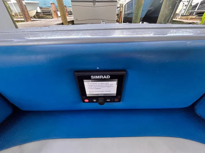  Yacht Photos Pics Simrad display on 2011 Statement 380 Open boat, docked with other vessels.