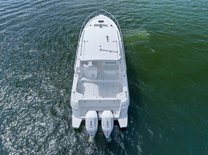 Tide Chaser Yacht Photos Pics 2022 Intrepid 438 Evolution boat on water, aerial rear view.