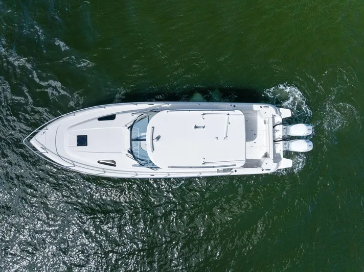 Tide Chaser Yacht Photos Pics Aerial view of 2022 Intrepid 438 Evolution yacht cruising on water.