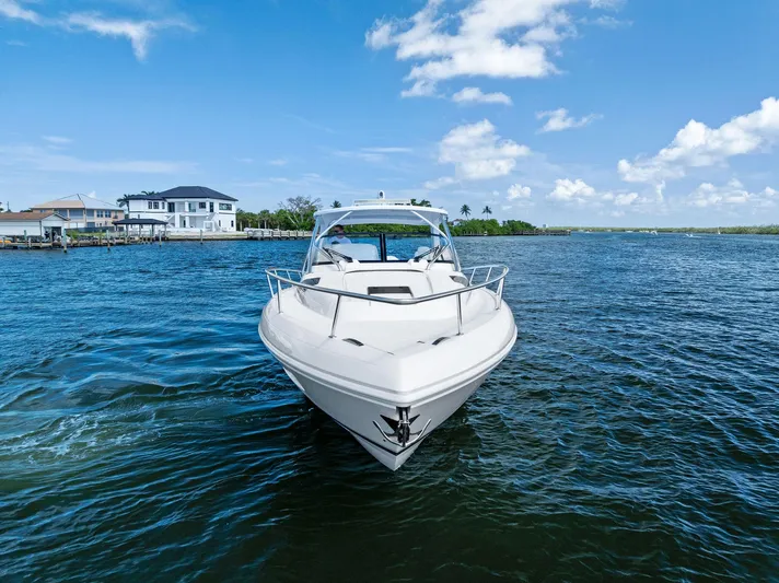 Tide Chaser Yacht Photos Pics 2022 Intrepid 438 Evolution boat cruising on a sunny day near waterfront homes.