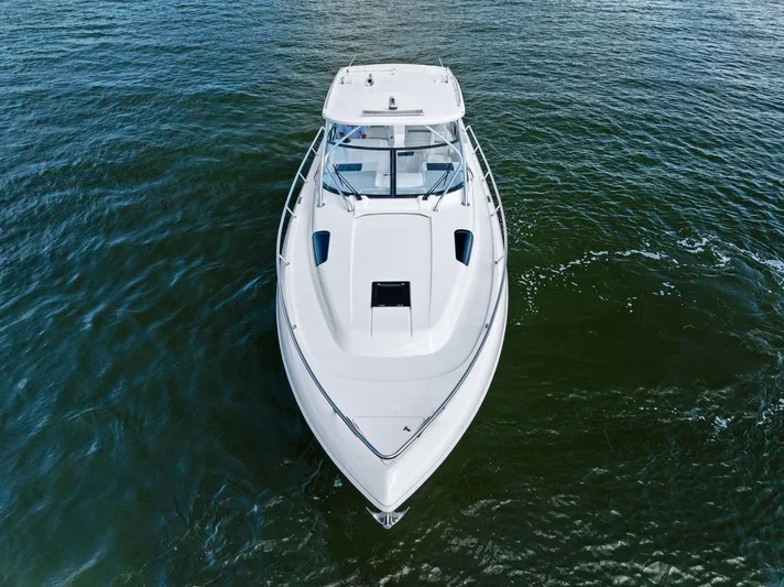 Tide Chaser Yacht Photos Pics 2022 Intrepid 438 Evolution boat on open water, aerial view.