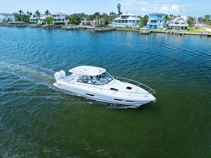 Tide Chaser Yacht Photos Pics 2022 Intrepid 438 Evolution cruising near waterfront homes.