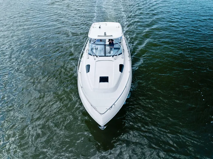 Tide Chaser Yacht Photos Pics 2022 Intrepid 438 Evolution boat cruising on open water, aerial view.
