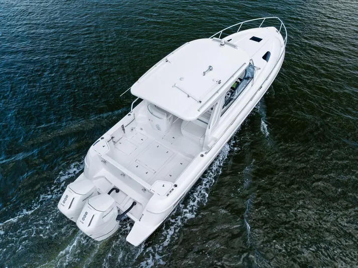 Tide Chaser Yacht Photos Pics 2022 Intrepid 438 Evolution boat cruising on open water, aerial view.