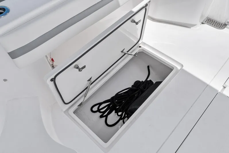Tide Chaser Yacht Photos Pics Storage compartment on 2022 Intrepid 438 Evolution boat with coiled rope inside.