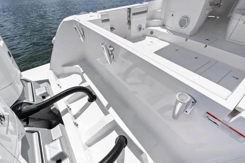 Tide Chaser Yacht Photos Pics 2022 Intrepid 438 Evolution boat deck with rod holders and storage compartments.