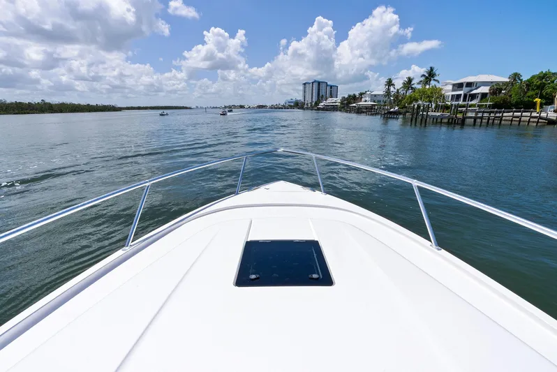 Tide Chaser Yacht Photos Pics Bow view of 2022 Intrepid 438 Evolution yacht cruising on a sunny day.