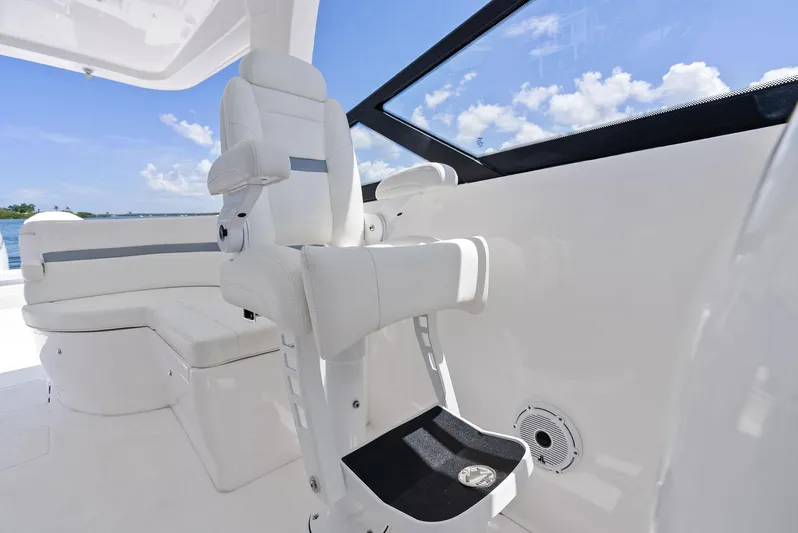 Tide Chaser Yacht Photos Pics Luxury seating on 2022 Intrepid 438 Evolution boat, featuring sleek white design and ocean view.